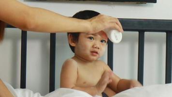 Asian moms and boys enjoy playing with baby powder at home. mother and son happy holidays video