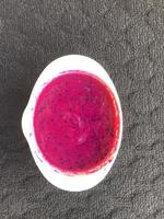 Dragon fruit that has become pulp for baby food on a dark background photo