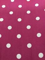 white polka dots on a pink background photo