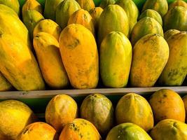 Papayas line the market - papaya fruit at the supermarket photo