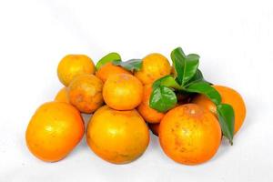 Fresh orange with leaves isolated on white cloth background photo