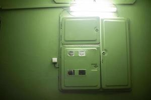 Electrical equipment in entrance of house. Electricity meter on floor. photo