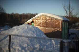 Shed in garden. House in country in winter. photo