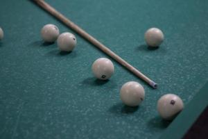 Billiard balls are white. Green billiard table. Playing in bar. Sports competition. photo
