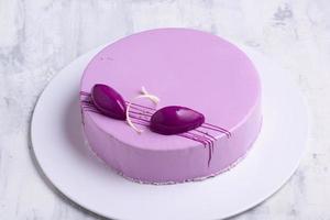 A top view shot of a purple cake on a white plate photo