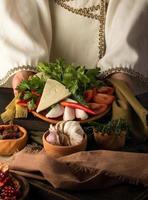 A vertical shot of a waitress presenting a appetizer dish photo