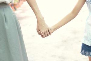 True love - Mother hold daughter hand with love and walk together photo