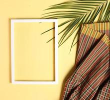 Summer background made from thai fabric and palm leaves photo