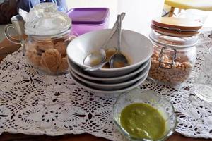 Pile of dirty bowls and two cake jars on the table photo