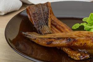 Eel on the plate and wooden background photo