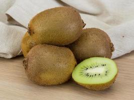 Kiwi fruit on wooden background photo