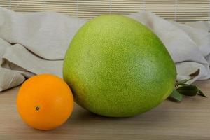 Green pomelo and orange photo