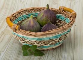 Figs in a basket on wooden background photo