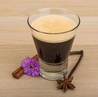 Espresso with flower on wooden background photo