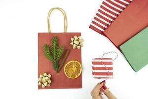 A woman decorates a present box for holidays or birthday photo