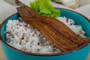 Eel with rice in a bowl on wooden background photo