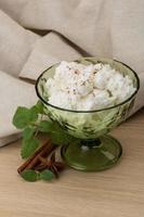 Ricotta cheese in a bowl on wooden background photo