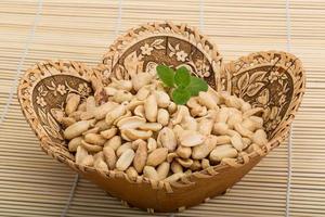 Peanut in a basket on wooden background photo