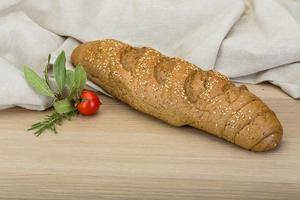 Cereal loaf on wooden background photo