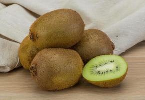 Kiwi fruit on wooden background photo