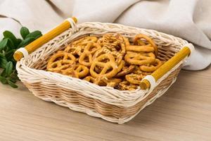 Pretzel in a basket on wooden background photo