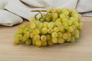 Green grape on wooden background photo