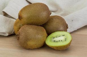 Kiwi fruit on wooden background photo