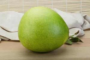 Pomelo on wooden background photo