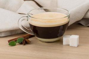 Cappuccino on wooden background photo