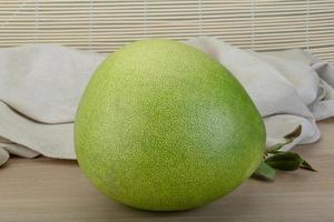 Pomelo on wooden background photo