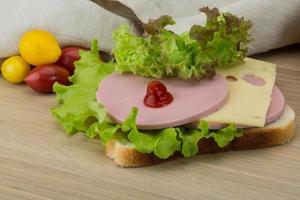 Sandwich with cheese and sausages photo