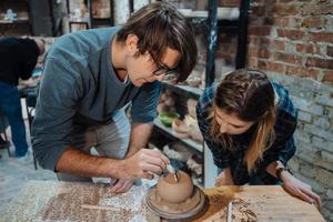 Making a handmade clay pot in the workshop. Pottery lesson, hobby. photo