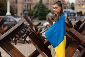 Young woman covered with the Ukrainian flag photo