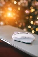 Modern wireless computer mouse on wooden table photo