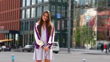 Playful portrait of pretty young woman, having fun at the street. photo