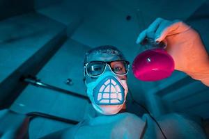 Young male researcher carrying out scientific experiment. photo