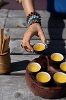 Top view tea set a wooden table for tea ceremony background. Woman and man holding a cup of tea photo