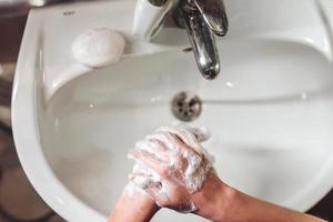 Man washing hands to protect against the coronavirus photo