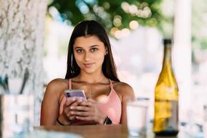 Photo of charming pretty young lady communicating modern gadget