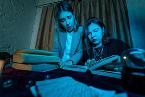 Two women are reading a mysterious book photo