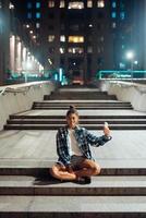 Woman talking via video call in the night city photo
