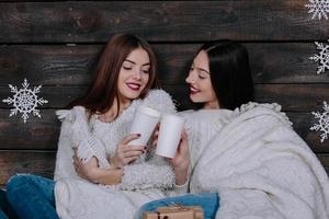 two girls drinking hot beverage photo