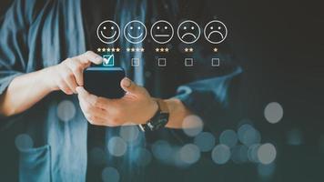 Man using a smartphone in give rating to service experience on application. Online customer review satisfaction feedback survey. photo