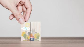 Hand holding with O3 chemical formula icon on wooden cube block with abstract cartoon city. Green office and urban concept. photo