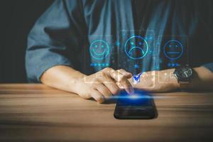 Man using a smartphone in give rating to service experience on application. Online customer review satisfaction feedback survey. photo