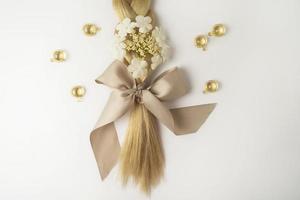 A natural essential oil or serum for hair care in golden capsules lying on a white table. Hair care and smoothing concept photo