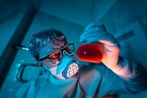 Young male researcher carrying out scientific experiment. photo