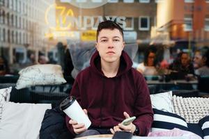 Handsome guy hanging out in an outdoor cafe photo