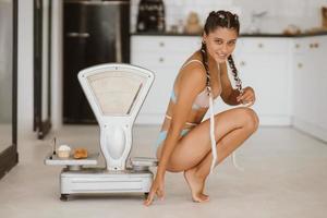 Woman in lingerie posing at the old grocery scales. Healthy eating concept photo