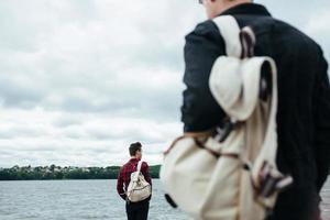 two young guys standing on a pier photo